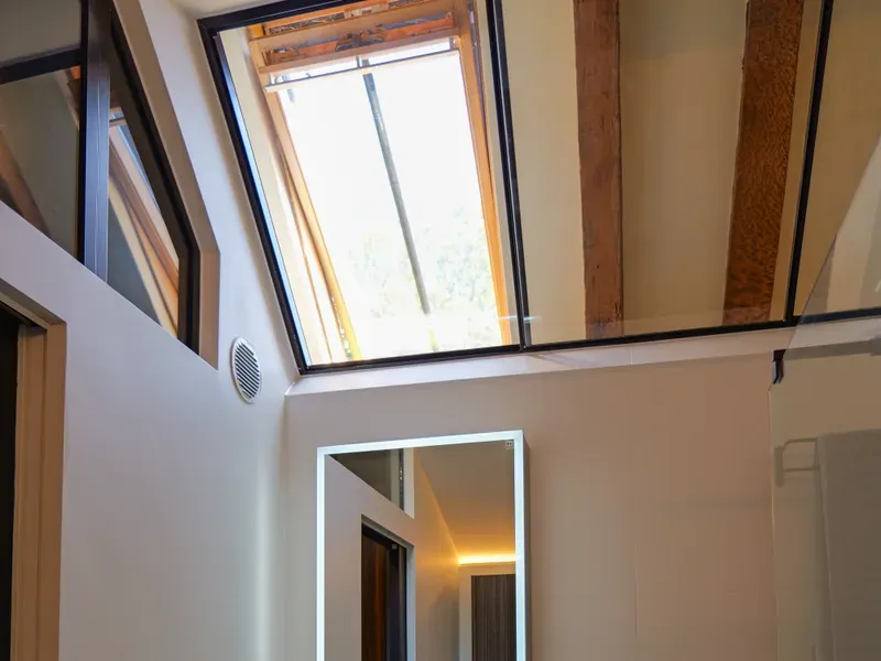 Spa-inspired bathroom with backlit mirror and basin